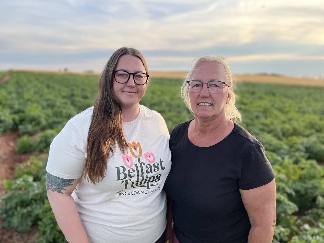 Two women stand on a farm