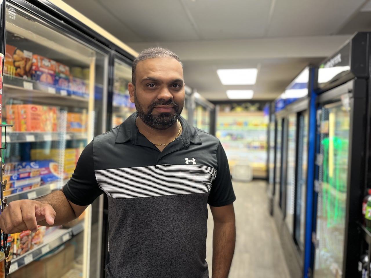 A man stands inside a general store