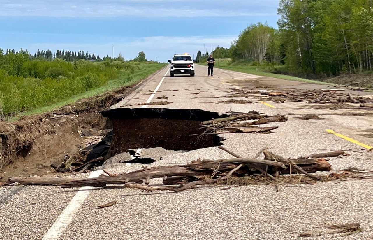 A large chunk of highway is washed away.
