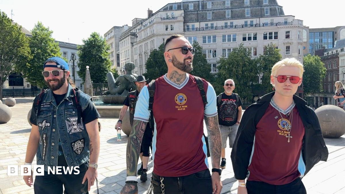 Three men wearing sunglasses, two wearing Aston Villa tops and a third wearing a denim jacket, gather in Victoria Square, Birmingham.