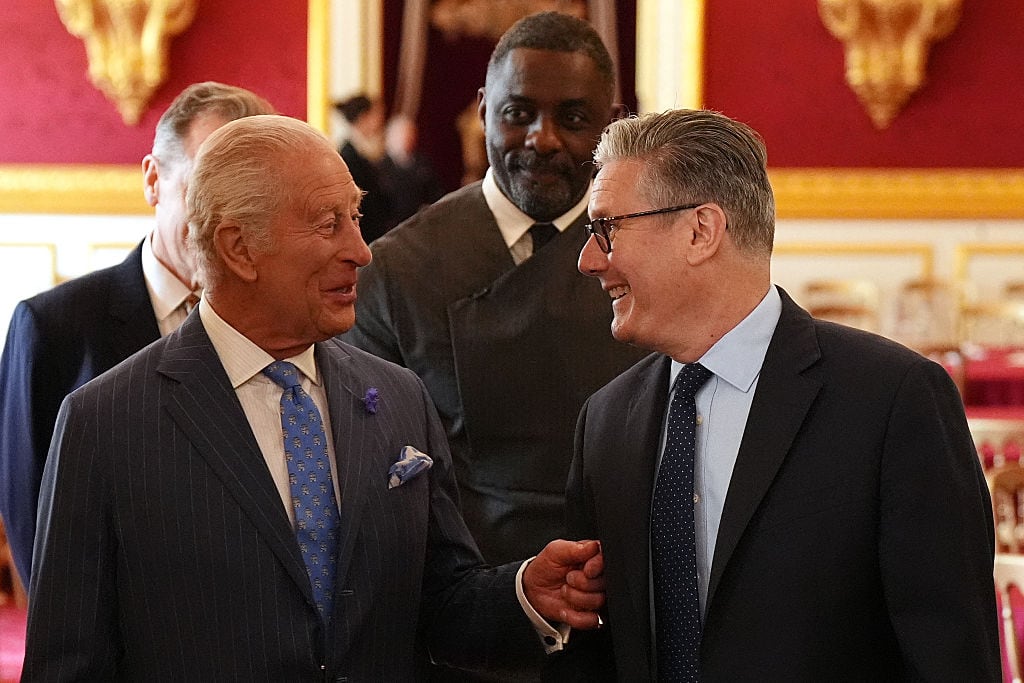 Two people smile while talking with one another.