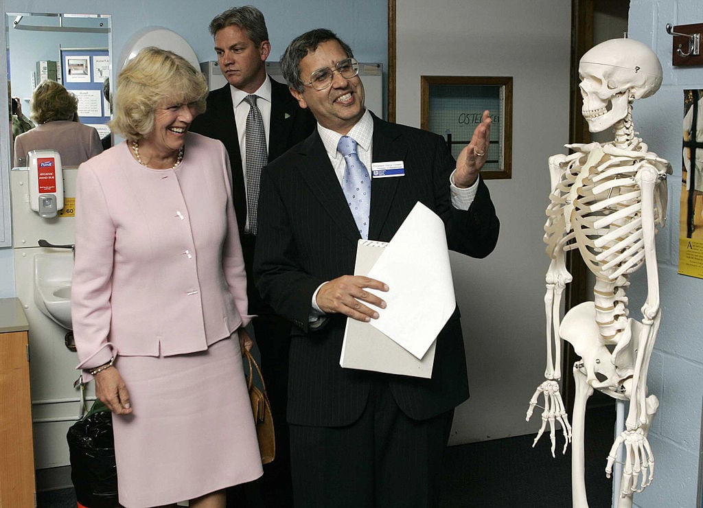 Two people look at a skeleton.