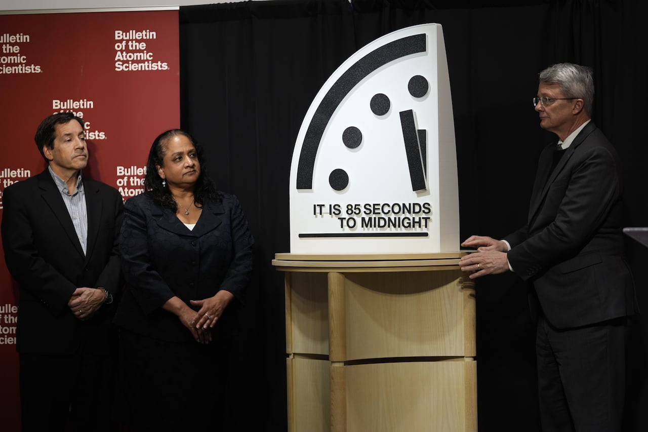 Three people and a clock.