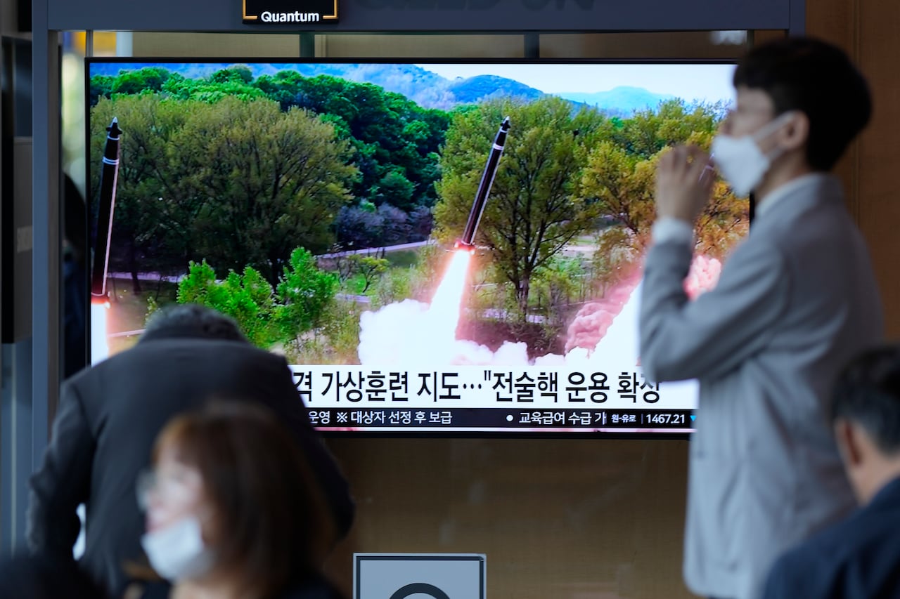 A TV screen shows a rocket launch.
