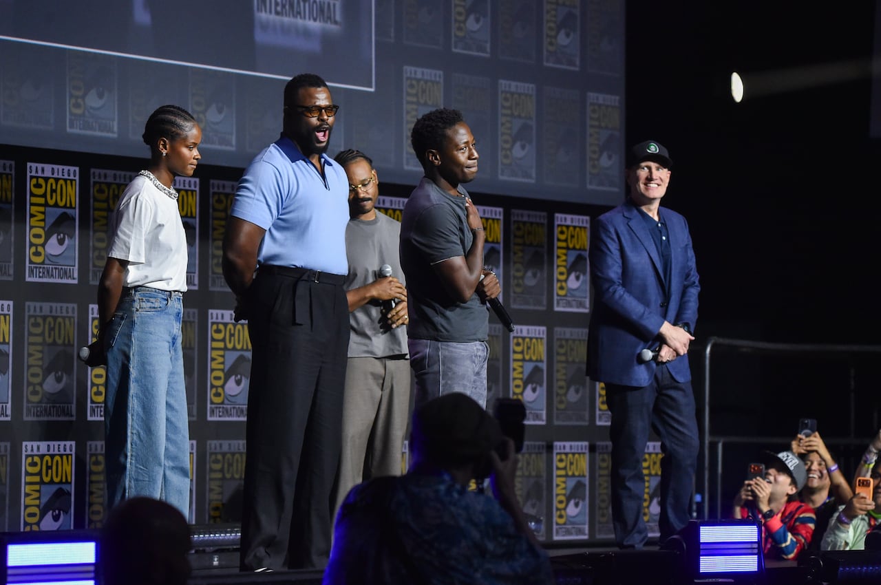 People on stage addressing an audience.
