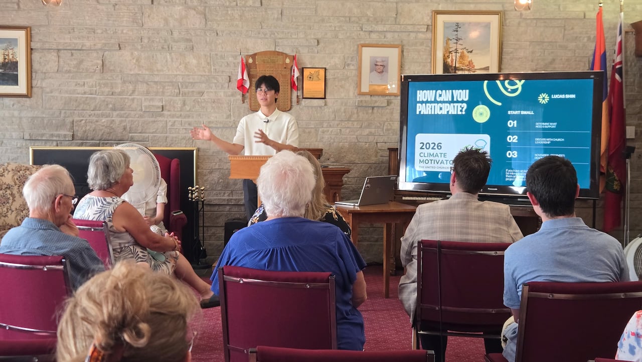 A young man making a presentation to a group of people at a church.