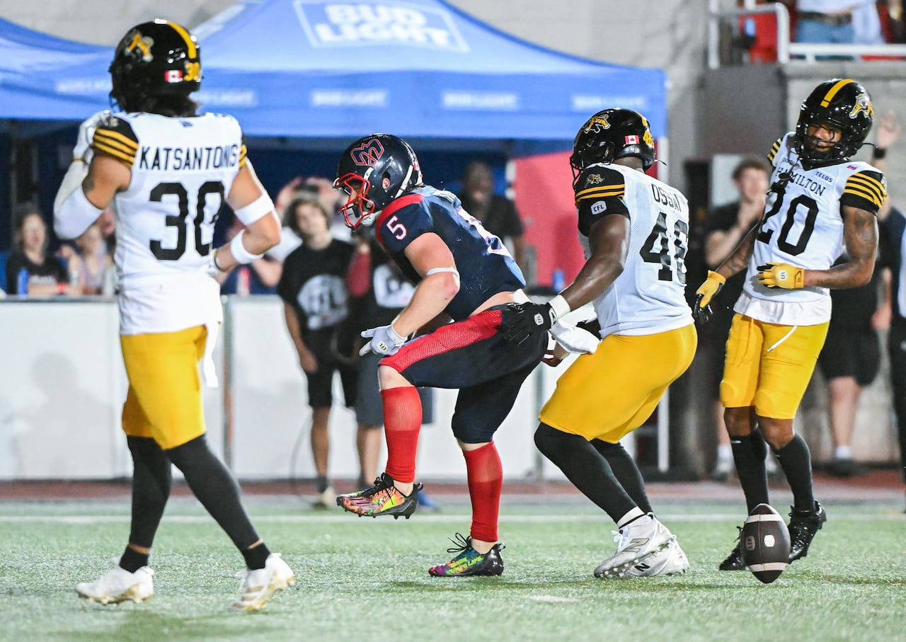 Montreal Alouettes' Travis Theis (5) reacts after scoring a touchdown during second half CFL football action against the Hamilton Tiger-Cats,