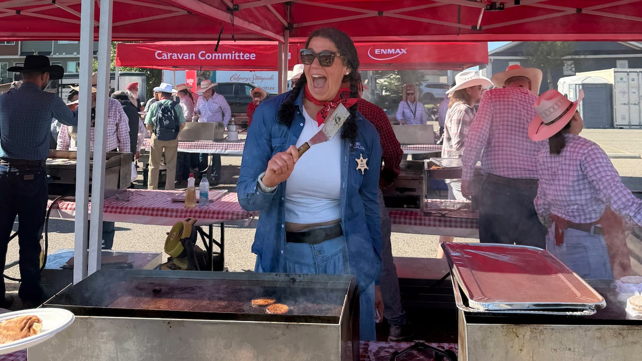 CBC's The Homestretch host Jenny Howe flipping pancakes at the Genesis Centre Stampede Breakfast