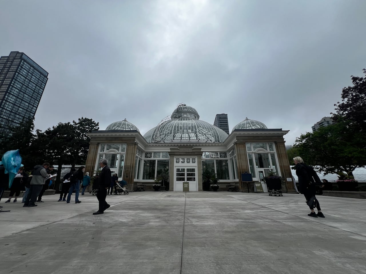People walk outside of the Palm House at Allan Gardens in Toronto.