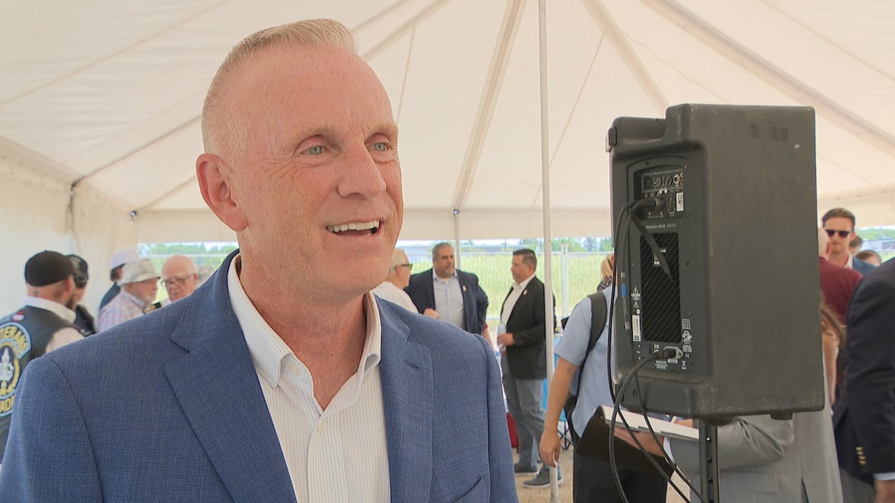 The president and CEO of the charity behind the veteran's village project speaking to a reporter on camera at the event.