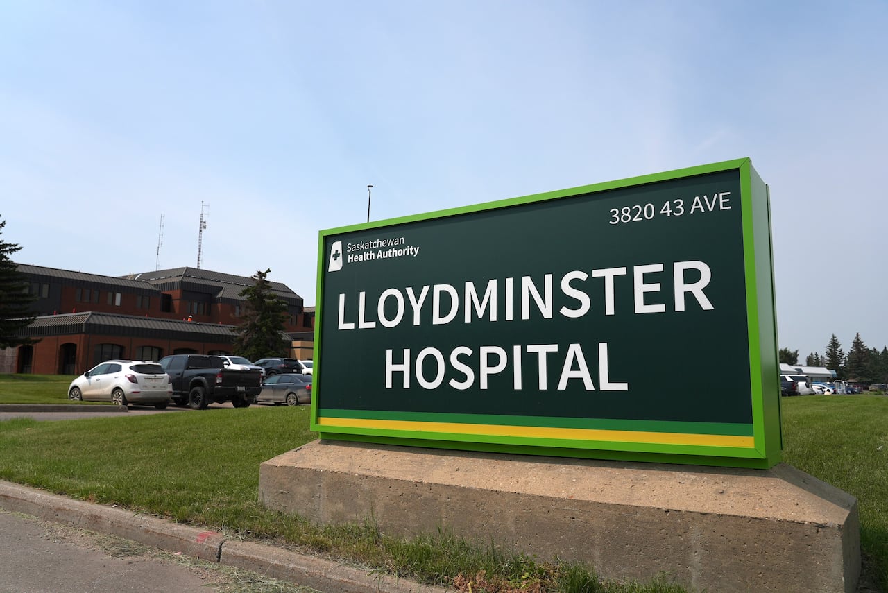 A sign that says "Lloydminster Hospital" outside a building on a bright day.