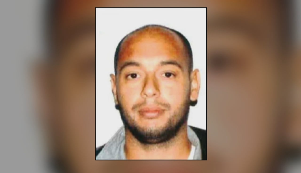A mugshot of a balding man with a light beard