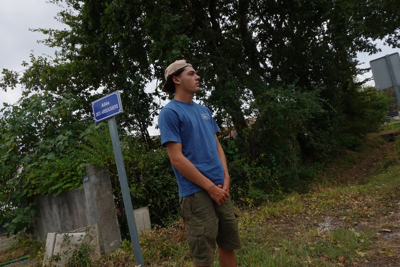 A young man looks off into the distance.