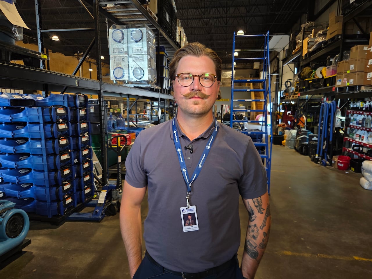 A man stands in a warehouse.