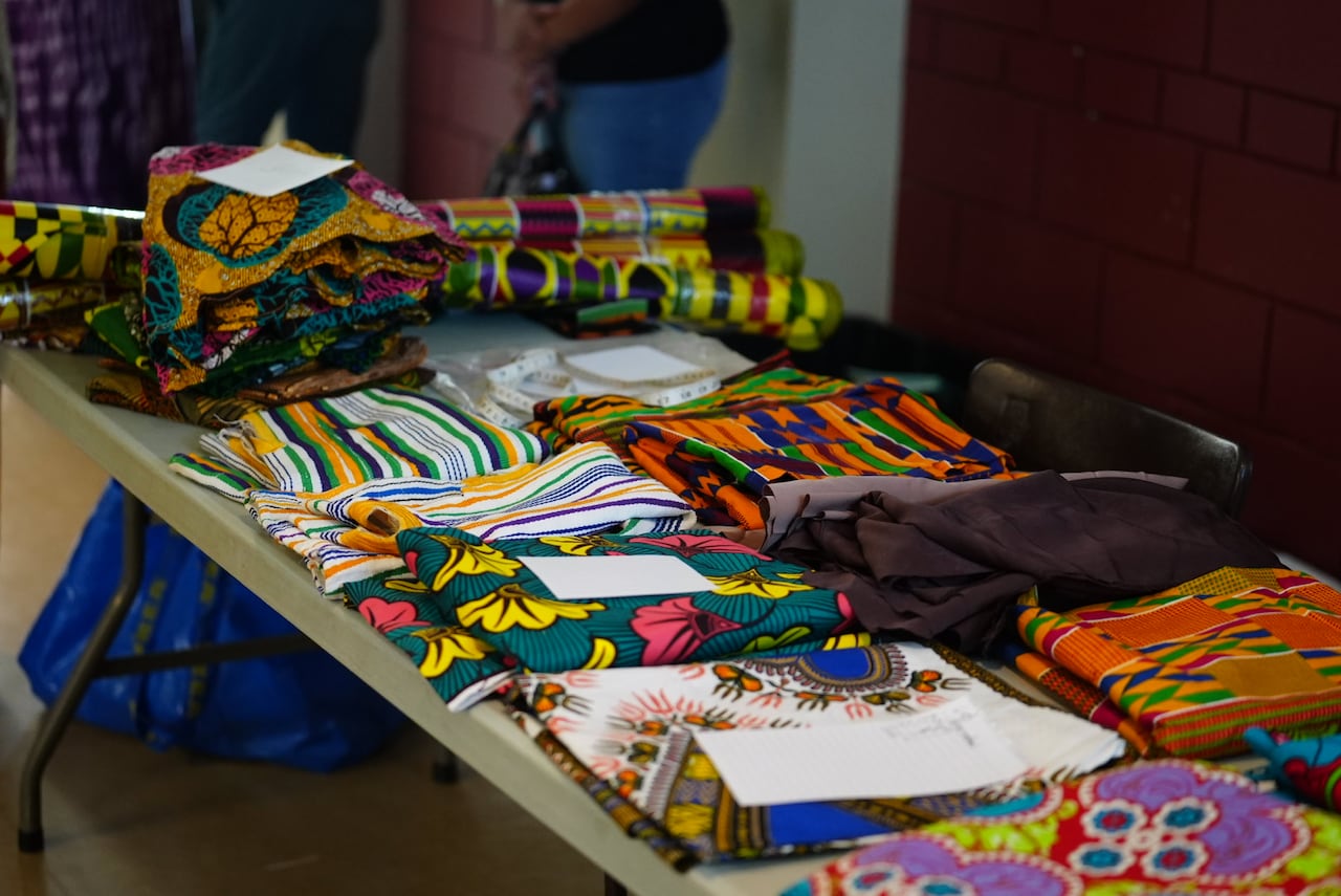 A table with various colourful fabrics on it.
