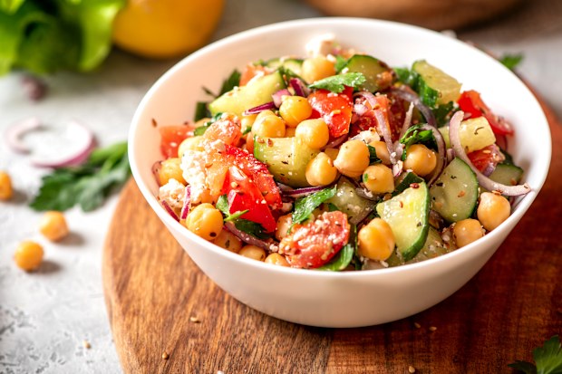 Chickpea salad with tomatoes, cucumber, feta cheese, parsley, onions and lemon