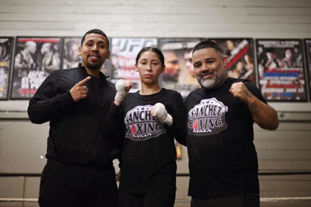 Competitive amateur boxer Halana Perez, 15, poses for a photo with her father Anthony Perez, left, and gym owner Rosendo Sanchez during a training session at Sanchez Boxing MMA in Santa Rosa on Monday, Jan. 29, 2024, the night before traveling to a national competition taking place in Kansas City, Missouri. (Erik Castro / For The Press Democrat)