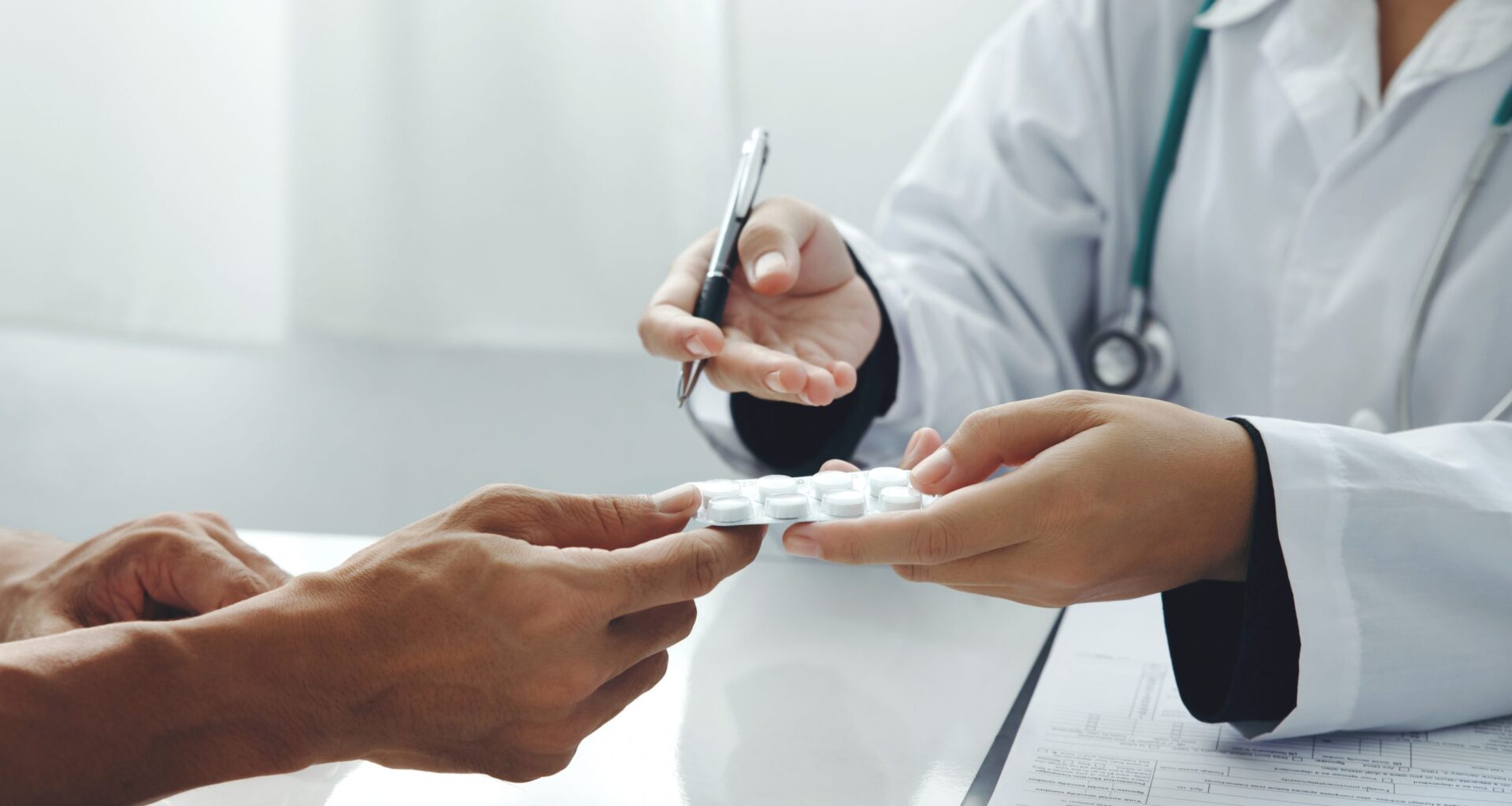 Close up of patient and doctor. Doctor giving prescription to the patient and explain the details of the medication.