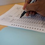 An election ballot being completed by a voter.