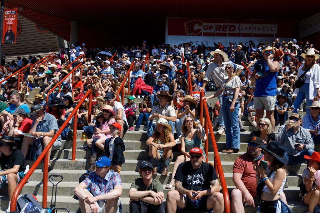People on the Saddledome steps watch a show on Stampede Park in Calgary