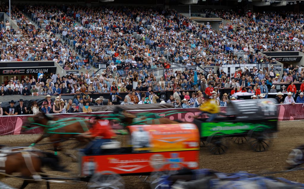 Chuckwagon racers speed ahead to claim first in their heat and in their overall time inside GMC Stadium in Stampede Park in Calgary on Friday, July 4, 2025