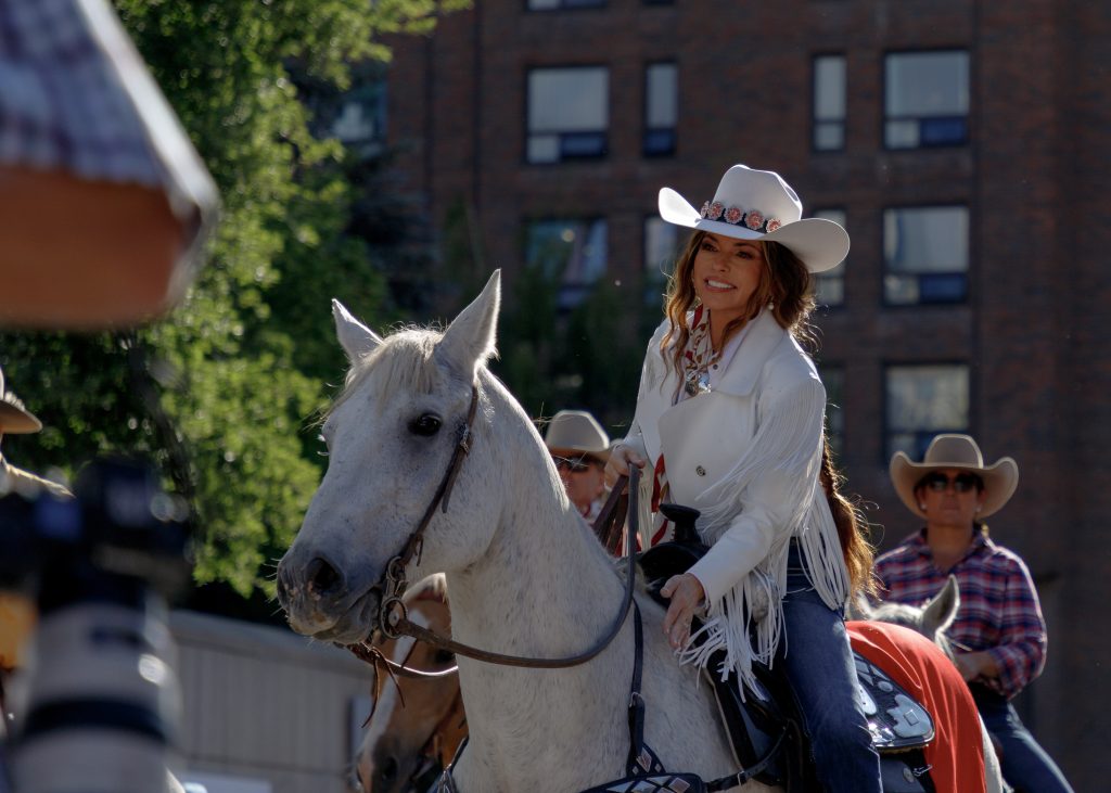 Country superstar Shania Twain pats her steed as they march together down 9 Avenue SE from the Confluence to kick off the Calgary Stampede Parade on Friday, July 4, 2025