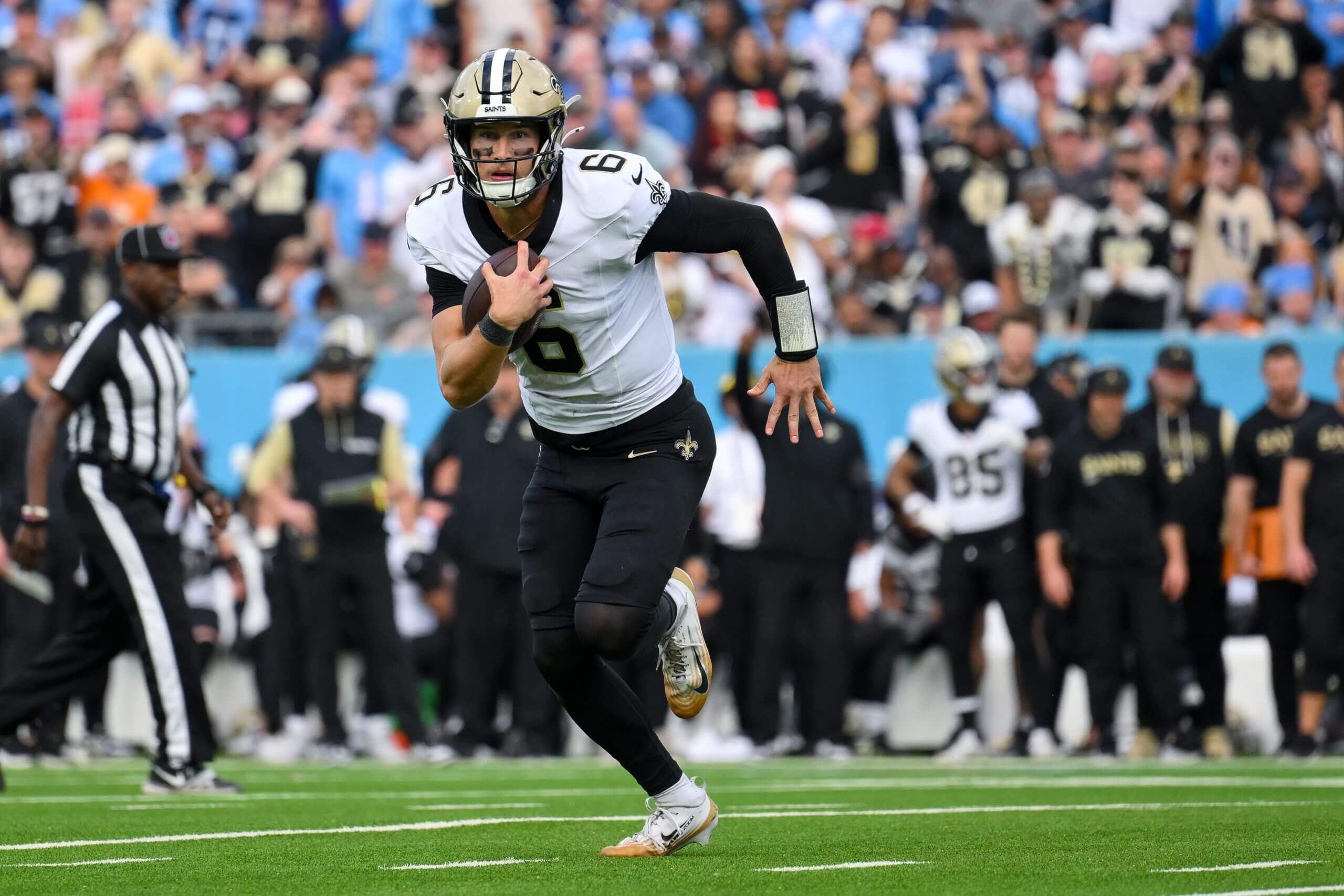 New Orleans Saints quarterback Tyler Shough (6) runs with the ball against the Tennessee Titans during the second half at Nissan Stadium.