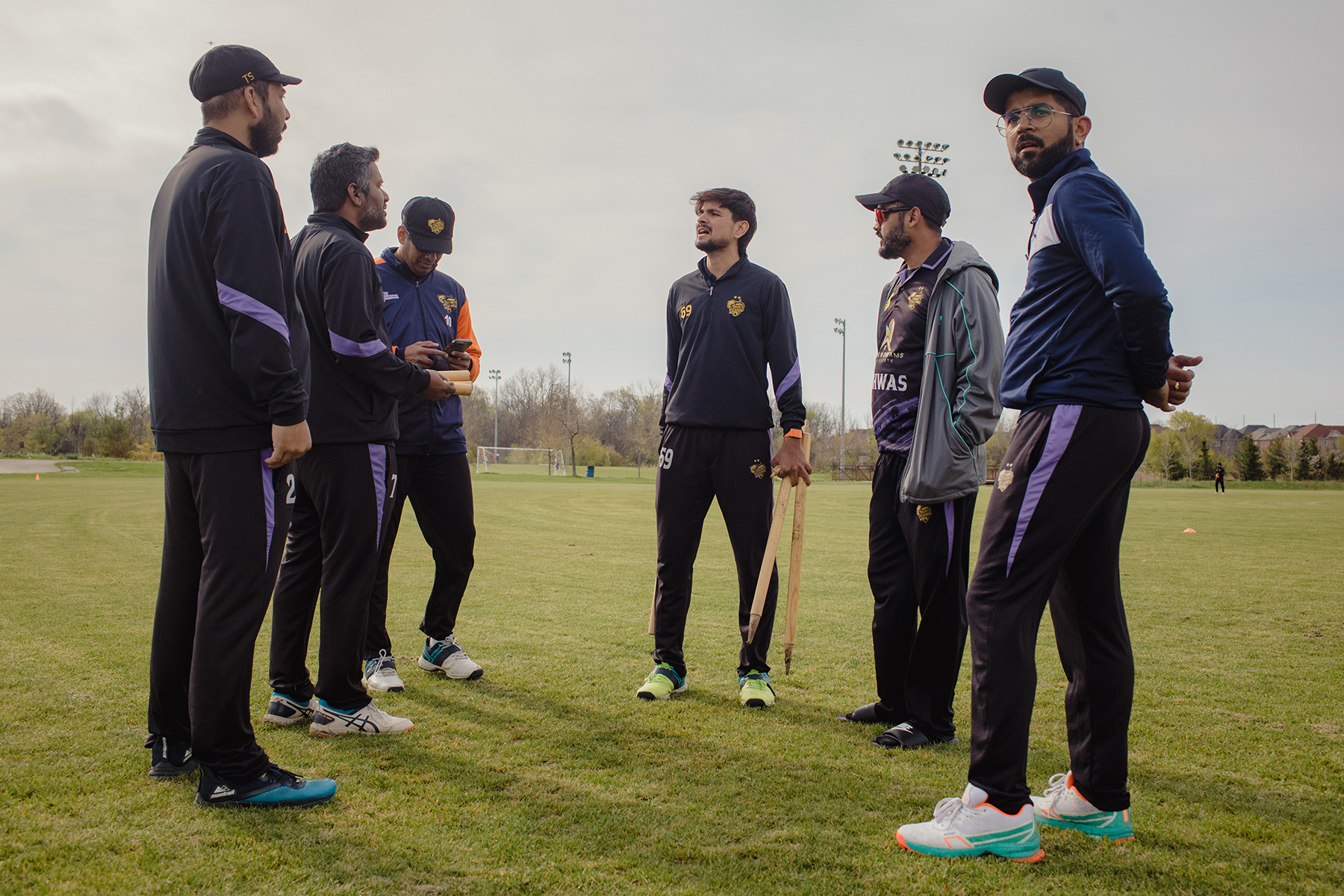 Tausif Shaikh and Ayyappan Pillai (first two from left) and their teammates convene during a break at a game at Andrew McCandless Park in Brampton.