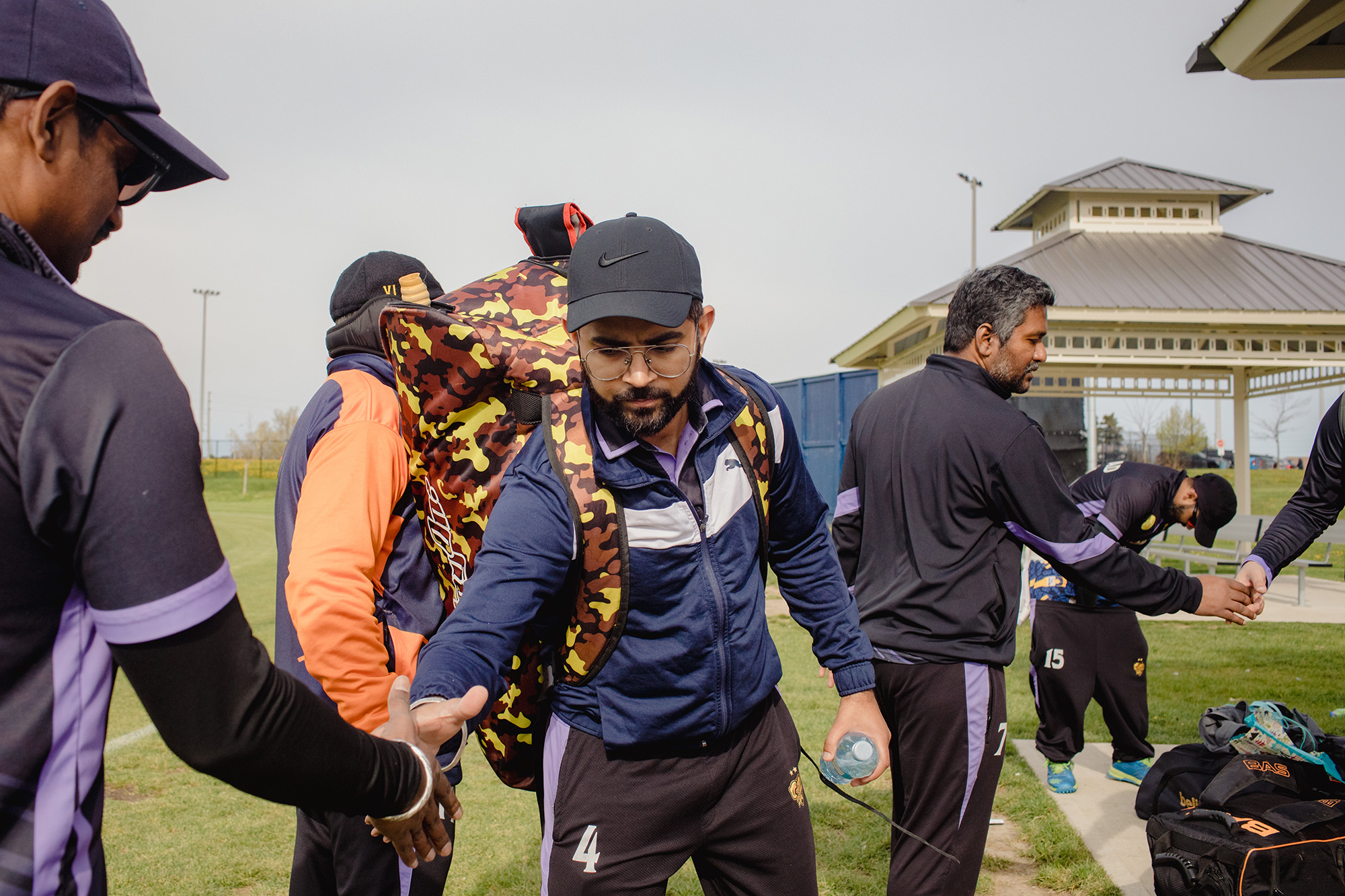 Toronto Peshwas team members shake hands at the end of a game in May.