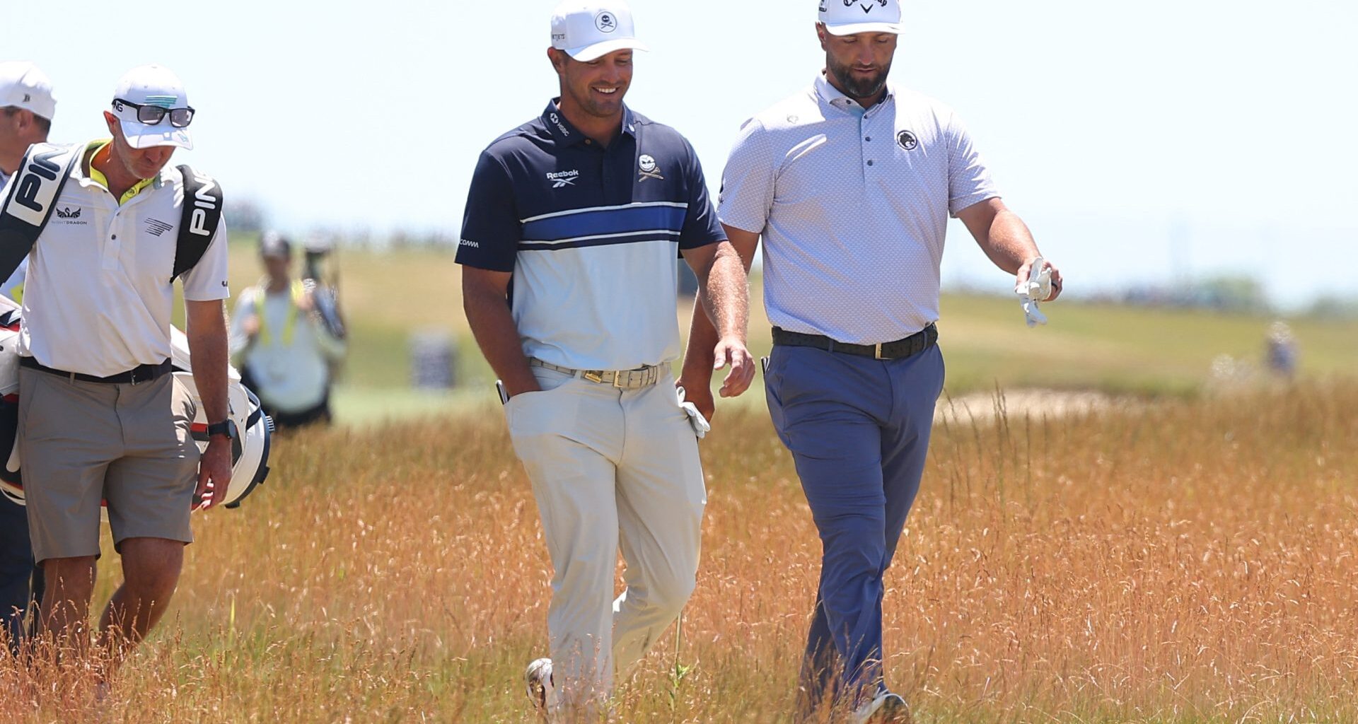 Jun 17, 2026; Southampton, New York, USA; Bryson DeChambeau (L) and Jon Rahm (R) walk together during a practice round for the U.S. Open golf tournament.