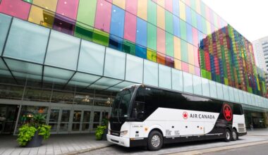 An Air Canada branded bus outside of the departure level at Montreal YUL Airport