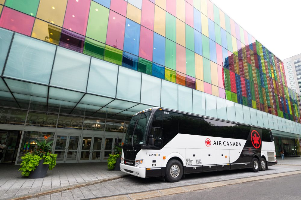 An Air Canada branded bus outside of the departure level at Montreal YUL Airport