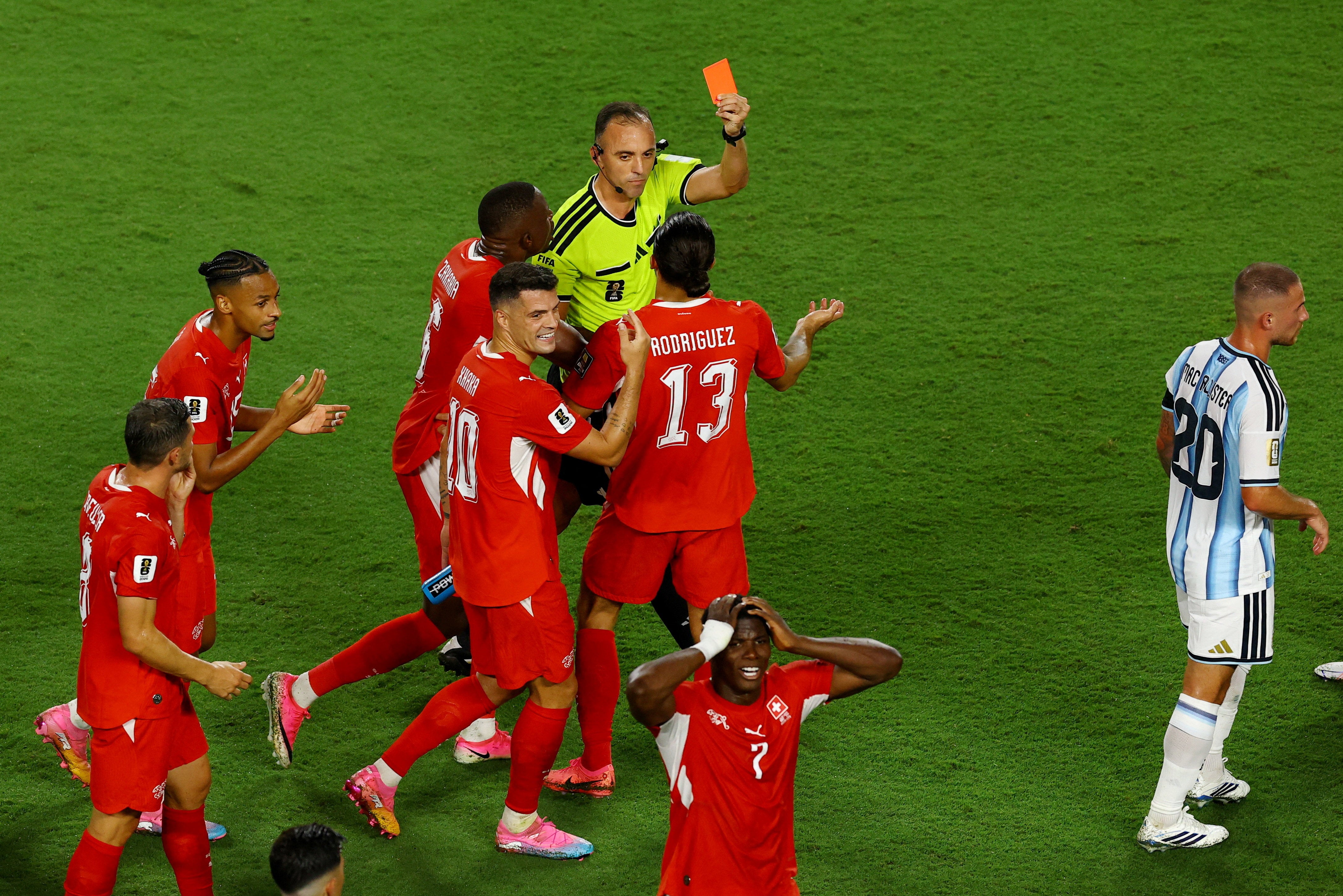 Switzerland's Breel Embolo is shown a red card by referee Joao Pinheiro after a VAR review
