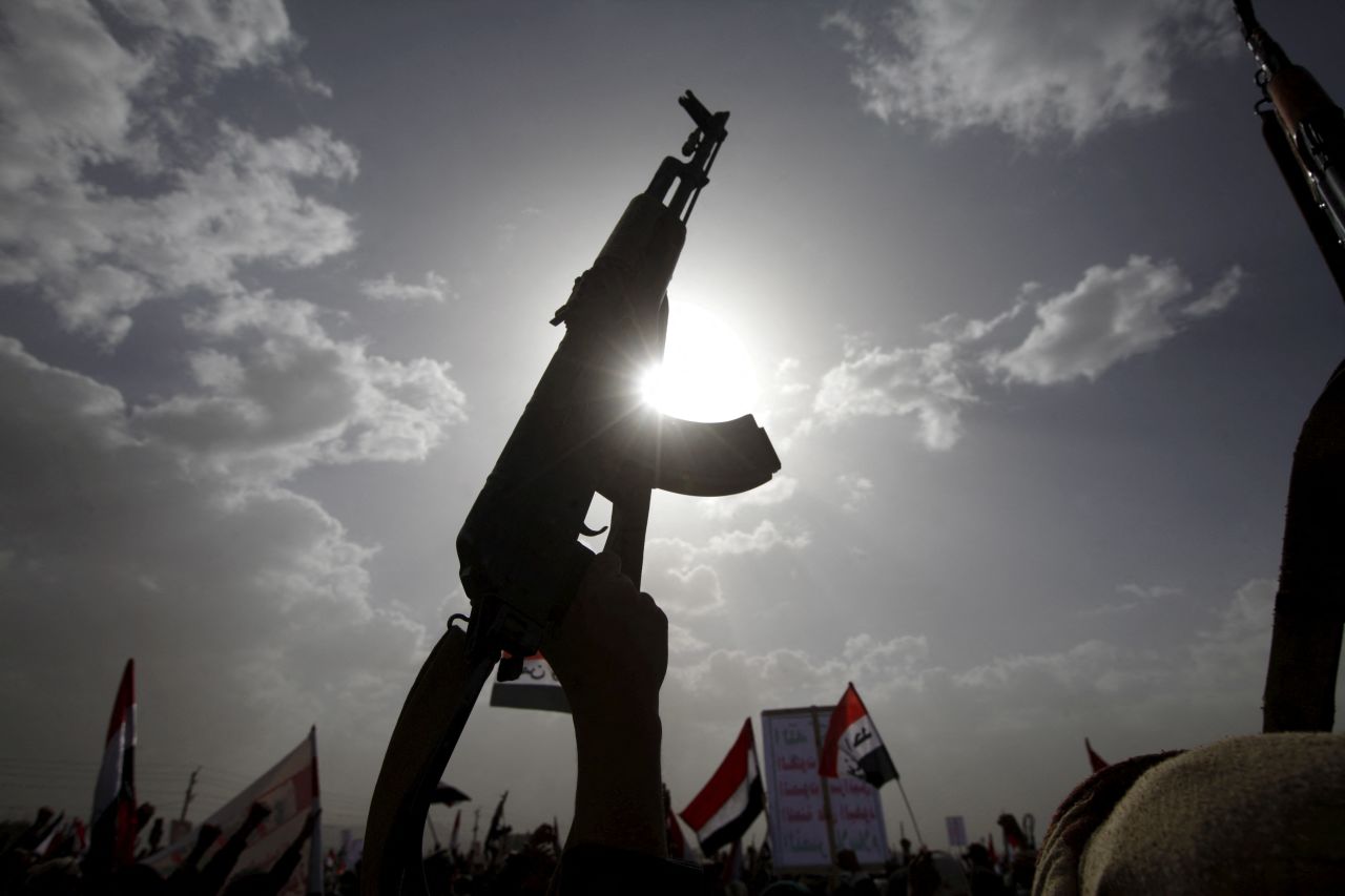 A Houthi follower rises a weapon as he attends a rally marking one year of Saudi-led air strikes, in Yemen's capital Sanaa in this March 26, 2016 file photo.