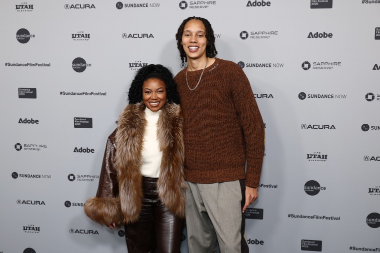 Cherelle Griner and Brittney Griner pose for a photo to be taken.