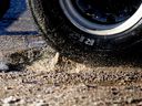 Motorists drive over a pothole along 118 Avenue at Groat Road, in Edmonton Tuesday March 10, 2026.