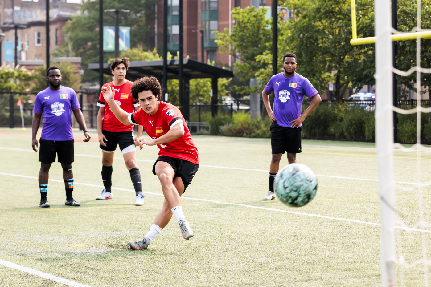 Students play soccer on a field.