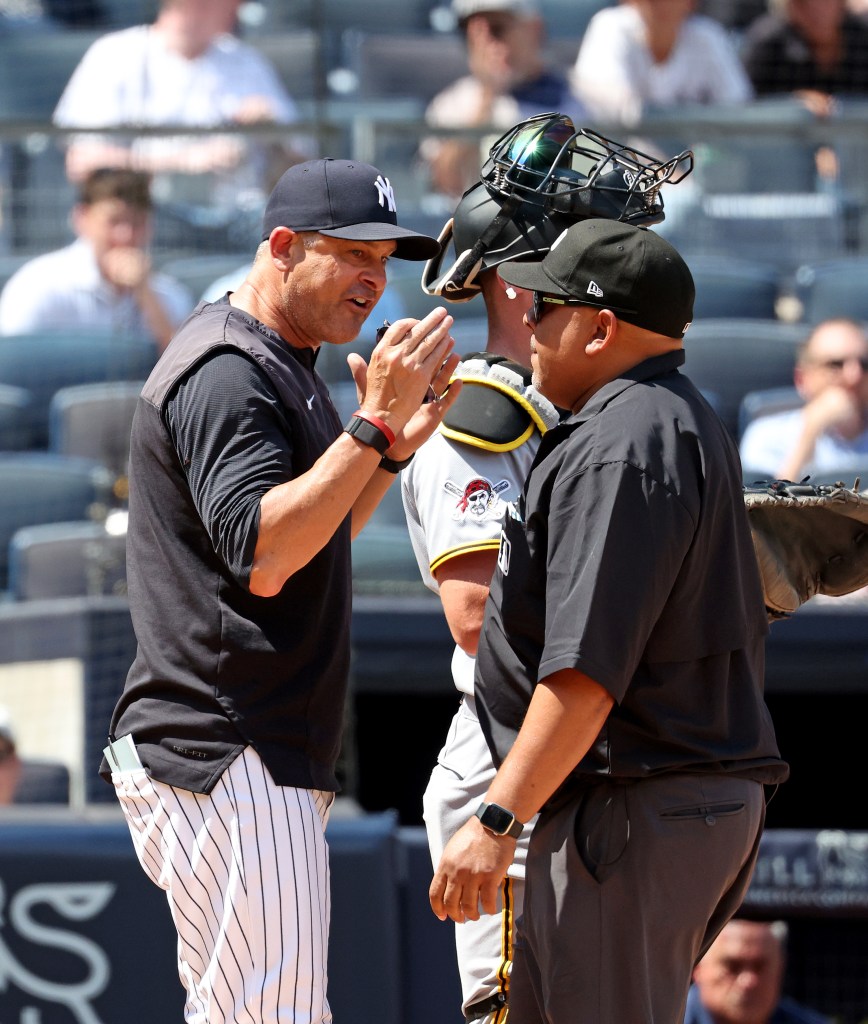 New York Yankees manager Aaron Boone (17) argues with a umpire after New York Yankees shortstop José Caballero (72) is called out on strikes during the sixth inning