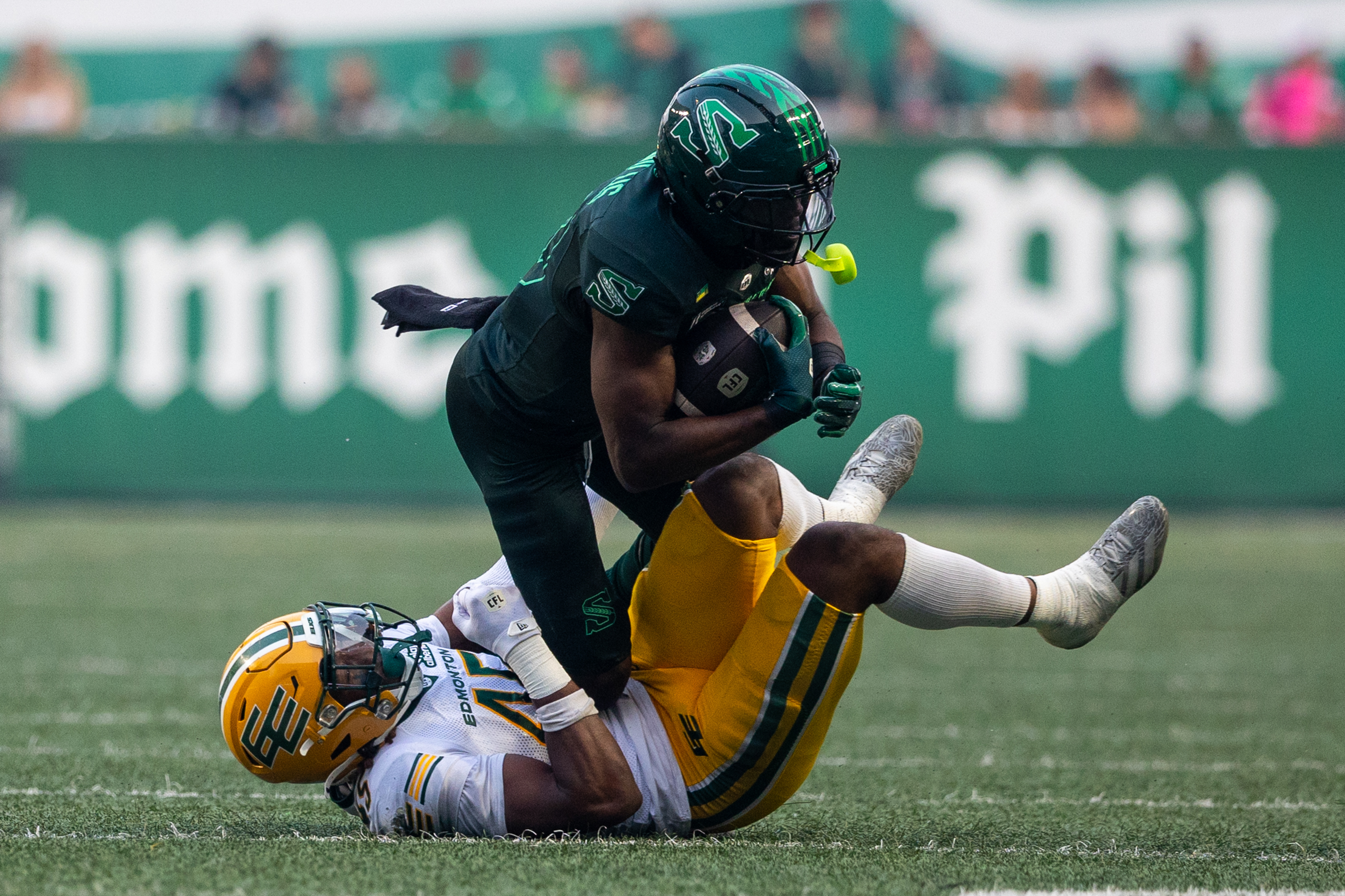 Saskatchewan Roughriders receiver Samuel Emilus (19) is tackled by Edmonton Elks linebacker Dariel Djabome (45) during the first half of CFL football action at Mosaic Stadium in Regina, on Thursday, July 23, 2026. (Regina Leader-Post/Heywood Yu)