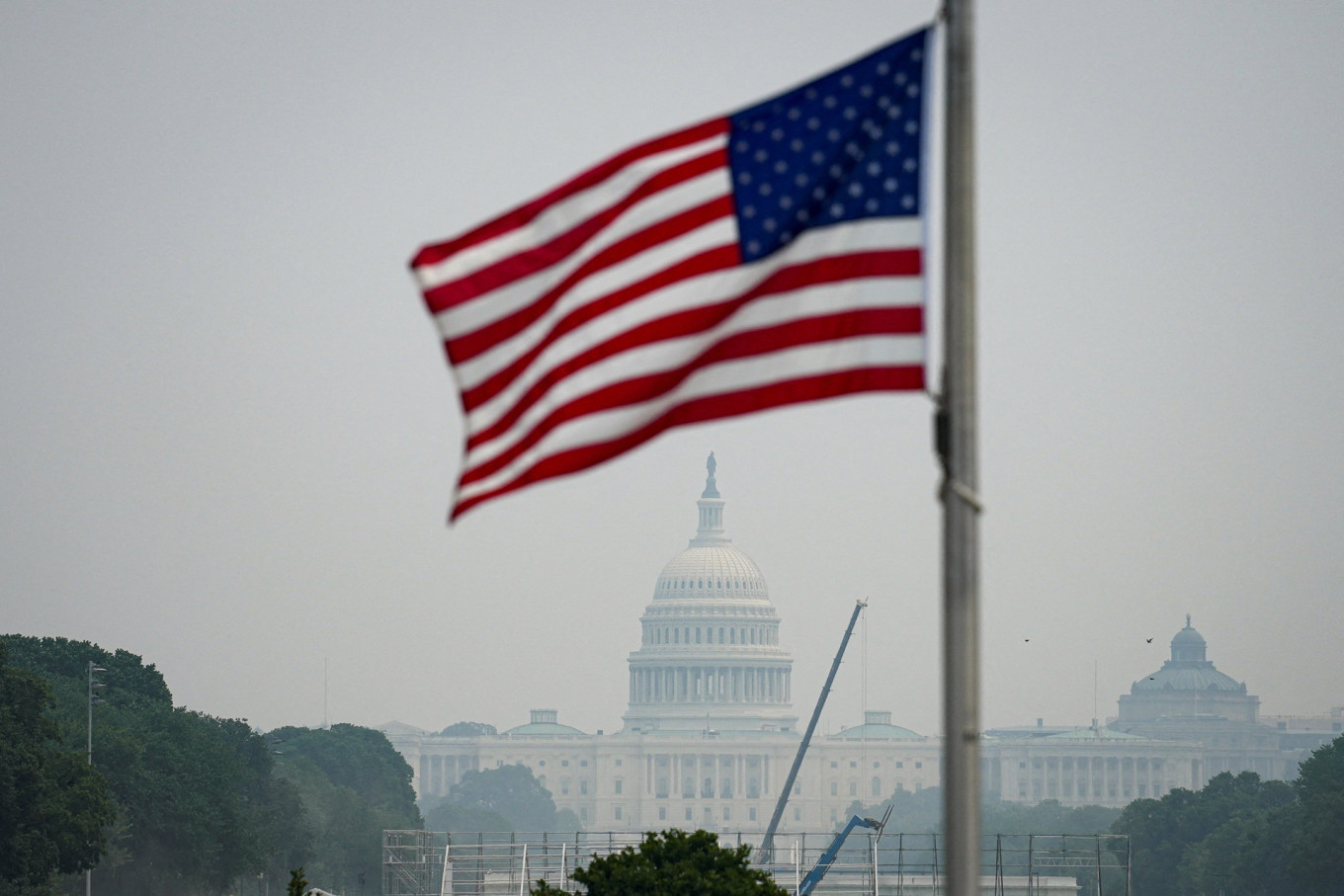 The United States Capitol and the US flag in smoky conditions due to the Canadian wildfires in Washington, D.C., the US, on July 17, 2026.