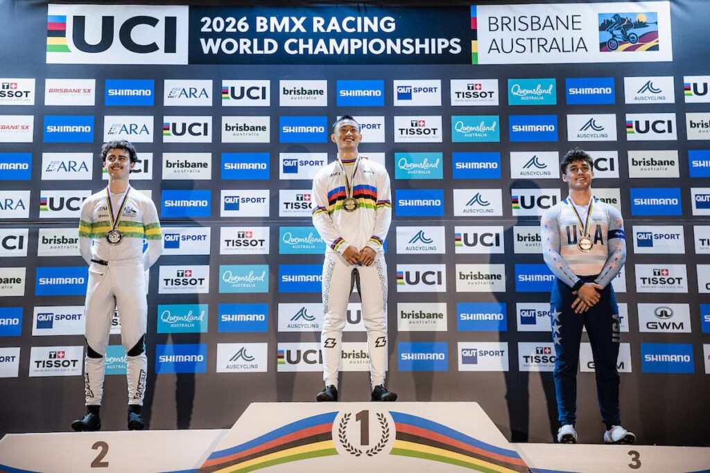 Riders standing on a podium