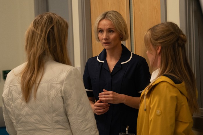 21_07_emm_charity_vanessa_02 Vaness and Charity talk to Helen in a hospital corridor in Emmerdale