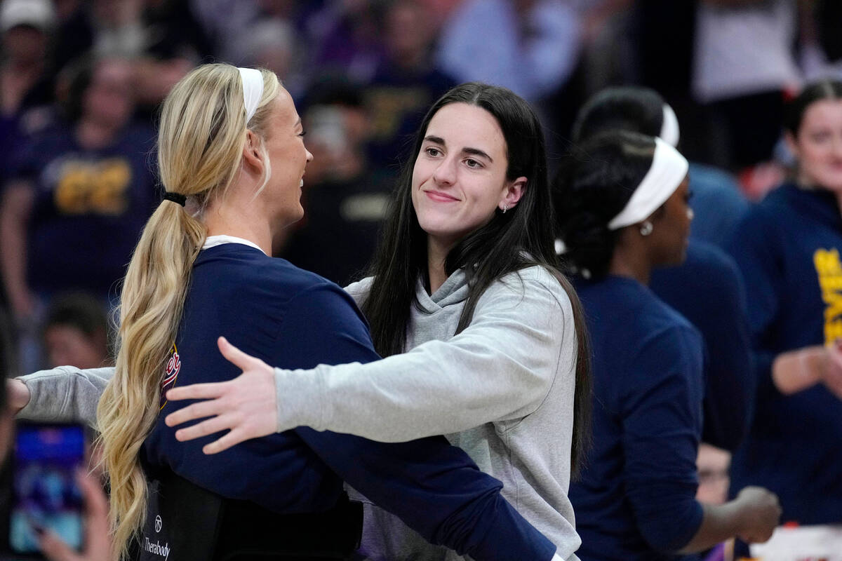Indiana Fever guard Caitlin Clark, right, hugs Fever guard Sophie Cunningham during player intr ...