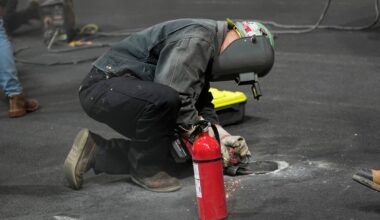 Work is performed on a manhole following the first practice session for the Formula One Las Veg ...