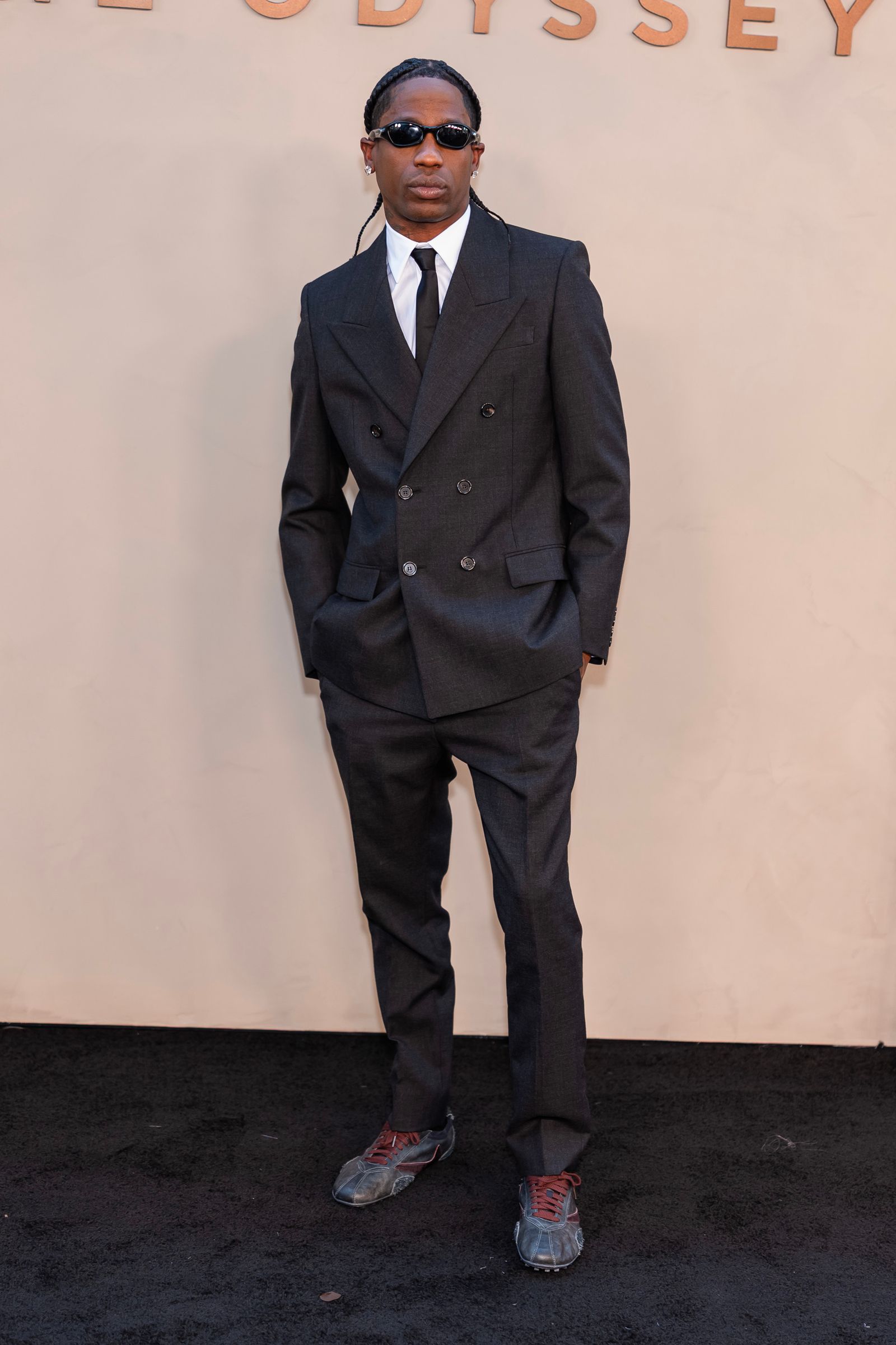 Image may contain Travis Scott Clothing Formal Wear Suit Person Standing Blazer Coat Jacket Adult and Tuxedo