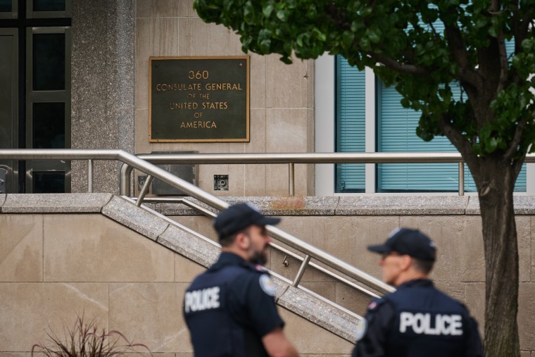 Police work the scene of an early morning shooting outside the US Consulate in Toronto.