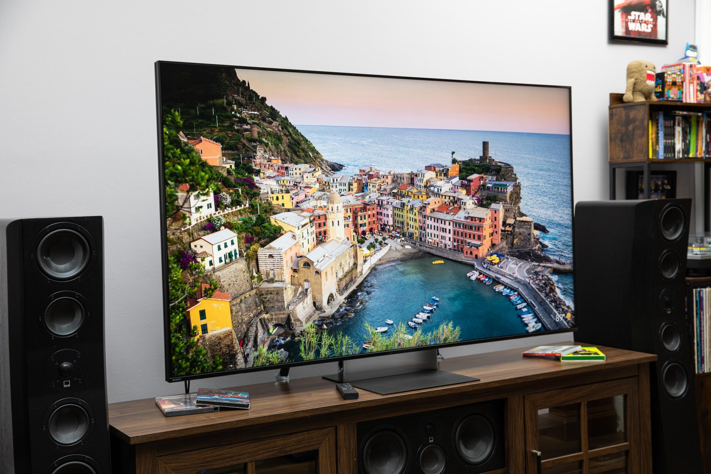 The Sony Bravia 9 II RGB LED TV on a wooden credenza with SVS speakers on either side.