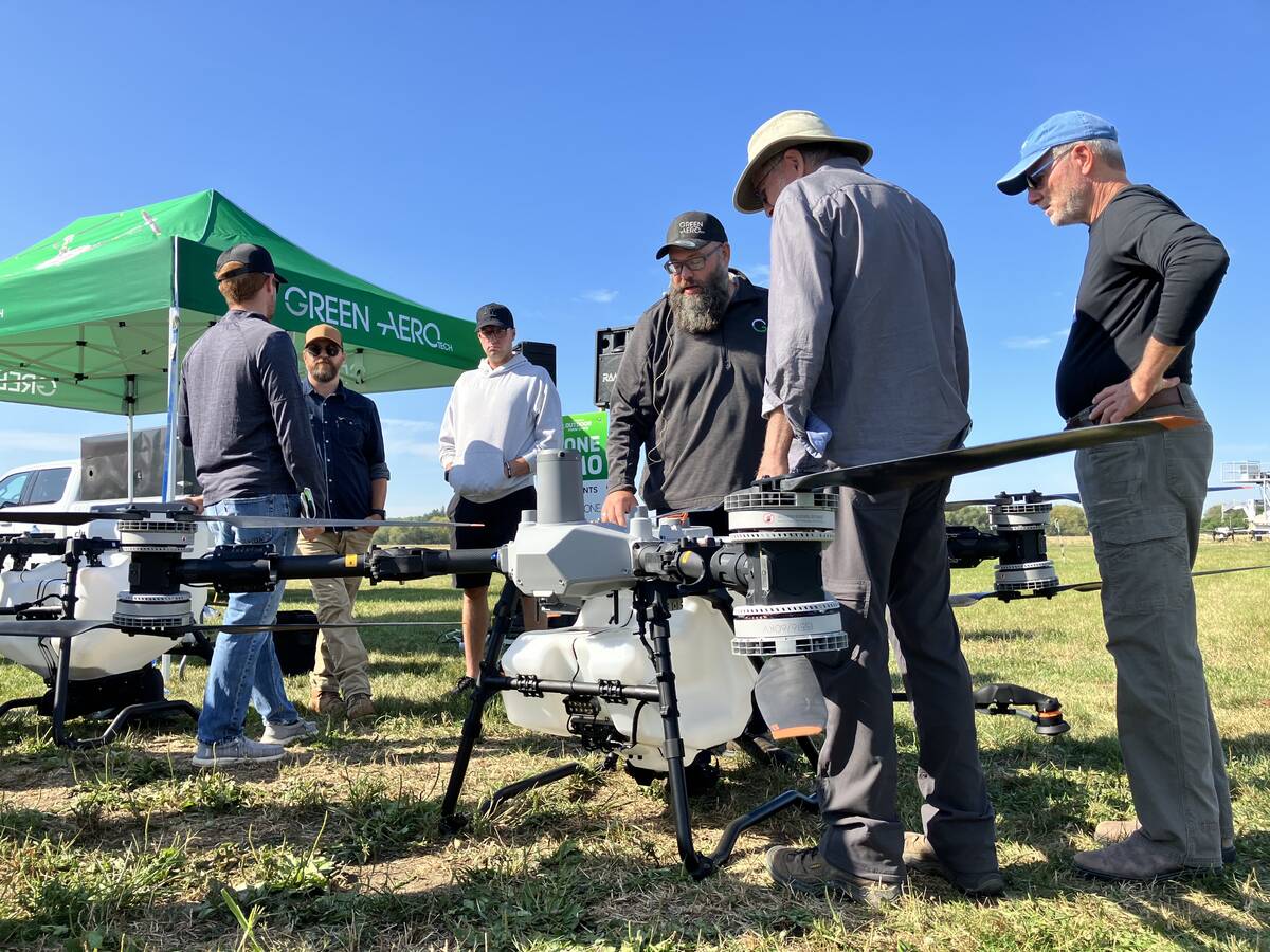 Warren Genick (centre) of Green Aero Tech with attendees at Canada’s Outdoor Farm Show in Woodstock, Ont., in September 2025. Photo: Greg Berg