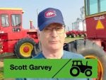 Scott Garvey in front of some vintage Versatile machinery at the AG in Motion farm show in 2026.