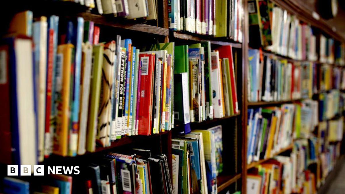 Books are crowded on a shelf.